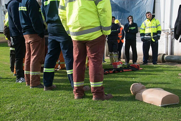 Outdoor first aid training with a group and CPR mannequin