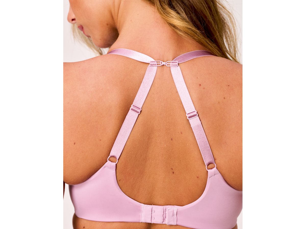 Mauve bra straps shown crossed across a model’s back