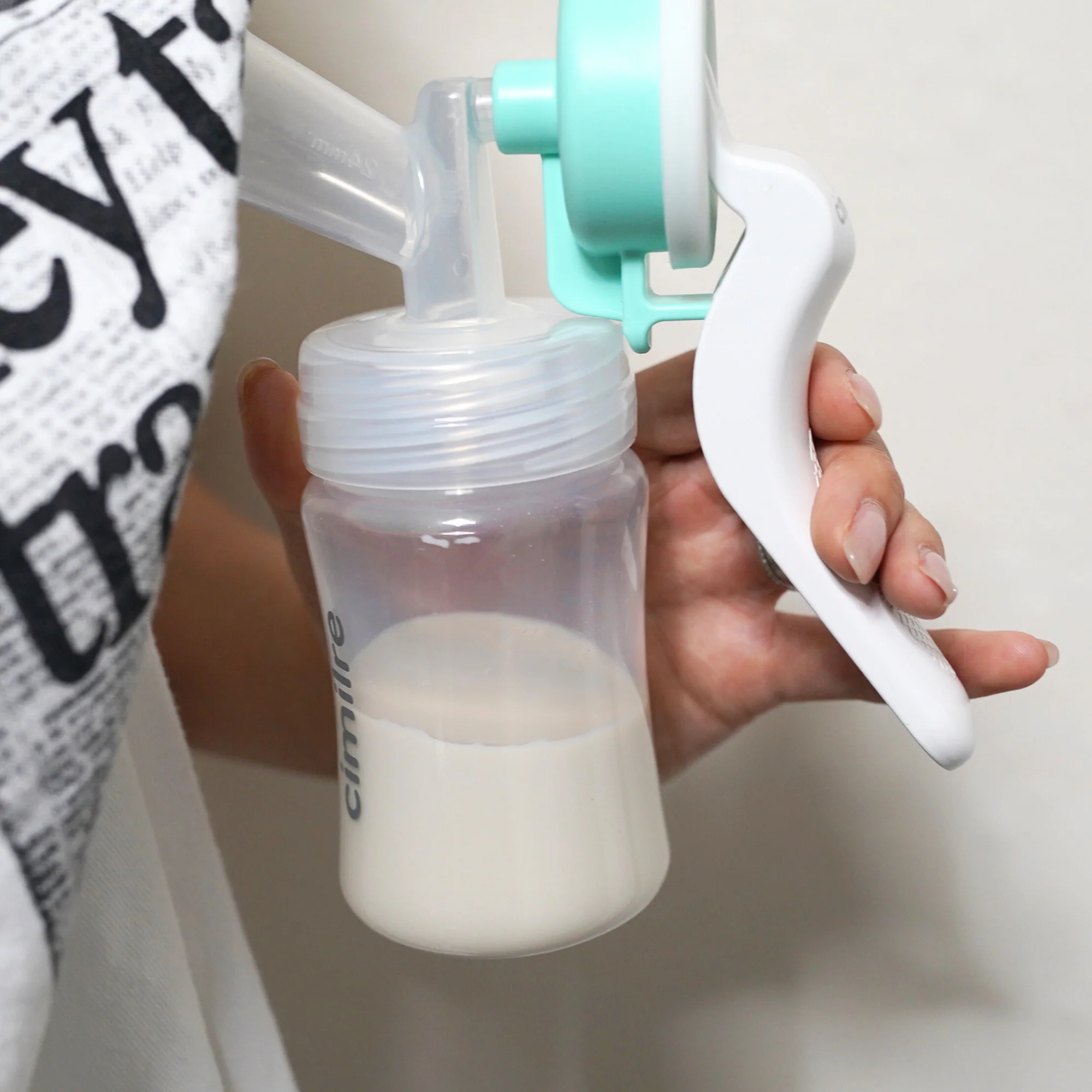 Person using a Cimilre M1 manual breast pump