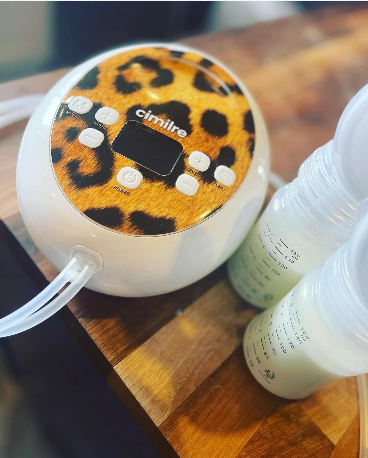 Cimilre S6 pump with patterned cover beside milk bottles