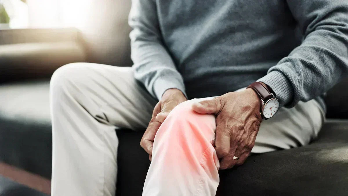 Person using red light therapy for joint support