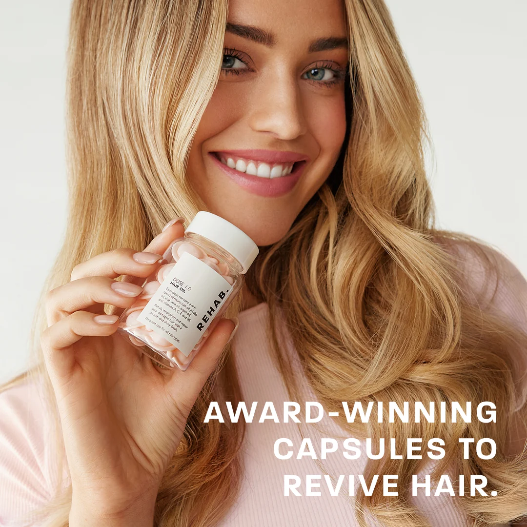 Dose 1.0 Hair Oil capsule bottle held by a model