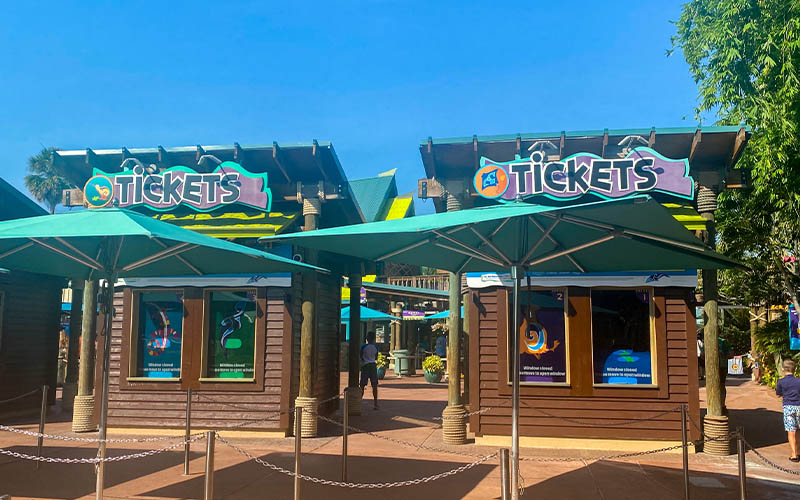 Aquatica Orlando ticket entrance beneath green umbrellas
